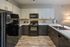 Modern kitchen with sleek black appliances, stylish cabinetry, and elegant countertops, perfect for culinary enthusiasts.