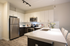 Modern kitchen with sleek stainless steel appliances, elegant countertops, and contemporary lighting, perfect for culinary enthusiasts.