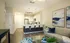 Modern open-concept kitchen and living area featuring sleek appliances, elegant artwork, and stylish furniture with a cozy ambiance.