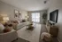 Inviting living room with cozy seating, chic decor, and abundant natural light from sliding doors.