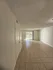 Bright and inviting living area with large windows and elegant tiled flooring, perfect for modern living.