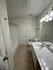 Modern bathroom with sleek countertops, large mirror, and elegant lighting, offering a fresh and inviting atmosphere.