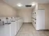 Bright and spacious laundry room with multiple washing machines and dryers, offering ample convenience for residents.