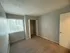 Bright and cozy bedroom with soft carpeting, large window for natural light, and spacious built-in closet.