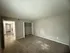 Spacious bedroom with plush carpet, open closet, and welcoming natural light, leading into a modern hallway.