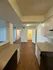 Inviting open kitchen concept with stylish cabinetry and warm wood flooring blending seamlessly into the living area.