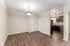 Contemporary apartment interior featuring an inviting open space with elegant wooden flooring, bright lighting, and a modern kitchen.