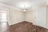 Inviting apartment entryway featuring elegant wood-style flooring and a modern light fixture.