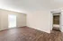 Bright, spacious room featuring elegant wood flooring and ample natural light, adjacent to a stylish tile-accented bathroom.