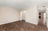 Spacious bedroom with elegant hardwood floors, walk-in closet, and seamless entry to a cozy living area.