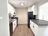 Modern kitchen with sleek black appliances, white cabinetry, and elegant countertops for stylish living.
