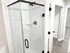 Modern bathroom featuring a sleek glass shower with white subway tiles and elegant fixtures.
