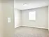 Bright, cozy bedroom with large window and soft carpet, ideal for comfortable living.