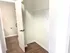 Modern walk-in closet with sleek wooden flooring and ample storage space.