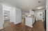 Inviting apartment interior featuring modern kitchen, cozy living space, and bright natural light through large windows.
