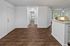 Inviting open-concept apartment entry with elegant hardwood flooring leading to a bright, spacious living area and cozy kitchen nook.
