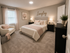 Inviting master bedroom with elegant decor, soft lighting, and plush bedding for ultimate relaxation.