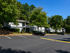 Charming residential apartment complex surrounded by lush greenery and ample parking space, offering tranquility and convenience.