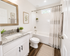 Modern bathroom with elegant granite countertop, stylish fixtures, and bright decor for a fresh, inviting atmosphere.