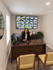 Modern leasing office with a friendly agent greeting visitors, featuring a surveillance display and inviting d&eacute;cor.