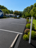 Charming residential complex with ample parking, vibrant landscaping, and tranquil green surroundings.