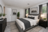 Upscale bedroom with elegant decor, featuring a plush bed, stylish nightstands, and chic wall art, complemented by soft lighting and tasteful greenery.
