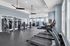 Modern fitness center with state-of-the-art equipment, including treadmills, weight machines, and an open design perfect for an energizing workout.