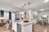 Modern open-plan living area featuring a sleek kitchen island, hardwood floors, and stylish dining space with contemporary decor.