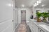 Luxurious modern bathroom featuring sleek granite countertops, elegant lighting, a spacious walk-in closet, and vibrant green plants for a refreshing ambiance.