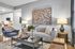 Contemporary apartment living room with plush seating, vibrant abstract art, and modern decor, flowing seamlessly into a sleek, open kitchen.