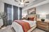 Inviting bedroom with a plush bed, elegant decor, and warm lighting, creating a cozy retreat.