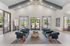 Elegant and spacious lobby with modern velvet armchairs, large windows, and designer lighting, creating a welcoming atmosphere.