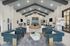 Elegant, spacious lobby area with modern design, featuring plush seating, stylish decor, and high vaulted ceilings.