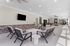 Elegant and modern communal lounge area featuring stylish seating, a flat-screen TV, and ample natural light.