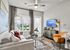 Chic living room with modern decor, featuring a cozy sofa, elegant glass coffee table, and warm accent lighting, perfect for relaxation and entertaining.