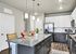 Modern kitchen with sleek granite countertops, elegant pendant lighting, and stylish cabinetry, creating a warm, inviting atmosphere.