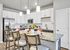 Modern kitchen with sleek stainless steel appliances, elegant pendant lighting, and a spacious granite island with seating.