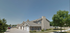 Charming townhouse complex with stone accents and neat garages, set in a tranquil neighborhood surrounded by lush greenery.