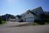 Charming suburban homes with spacious driveways and lush greenery under a clear blue sky.