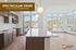 Bright open-concept kitchen and living area with stunning large windows offering spectacular views of a serene neighborhood at Hideaway Heights.