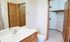 Bright and inviting bathroom with sleek vanity, modern fixtures, and spacious walk-in closet.