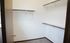 Spacious walk-in closet with elegant shelving and ample storage space, perfect for organizing your wardrobe.