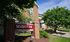 Charming brick apartment complex Silverstone surrounded by lush greenery and vibrant landscaping.