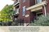 Charming red brick apartment exterior at Aspen Ridge with inviting balconies and lush greenery.