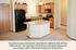 Cozy kitchen with modern appliances and stylish wooden cabinets, accented by contemporary lighting and a central island.