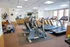 Modern fitness center with state-of-the-art exercise equipment and bright natural lighting.