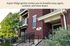 Aspen Ridge exterior showcasing charming red brick facade, inviting balconies, and lush greenery in a serene setting.