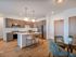 Inviting kitchen with modern cabinetry, sleek countertops, and cozy dining area for welcoming ambiance.