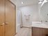 Modern bathroom with sleek fixtures, elegant double doors, and a clean, inviting atmosphere.