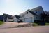 Charming suburban homes with spacious driveways, nestled in a serene neighborhood, featuring elegant architecture and well-maintained lawns.
